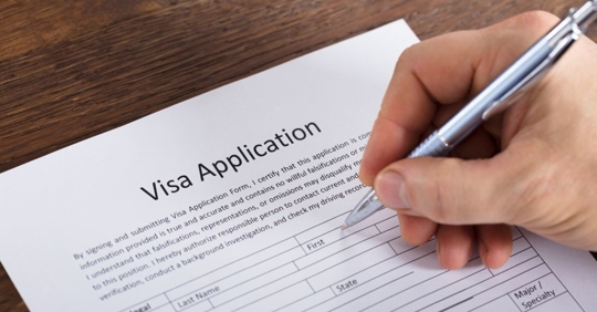 Immigrant filling out a Visa Application