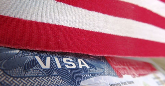 Visa with American flag draped over it