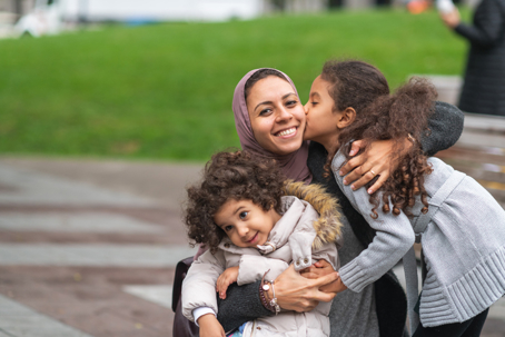 happy mother hugging children