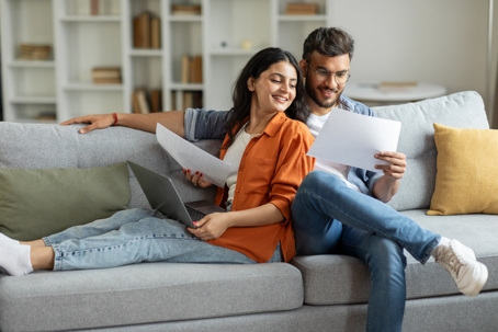 happy couple reviewing documents at home