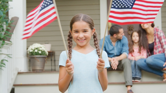 happy girl waving US flag