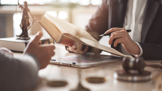 client in a discussion with an attorney