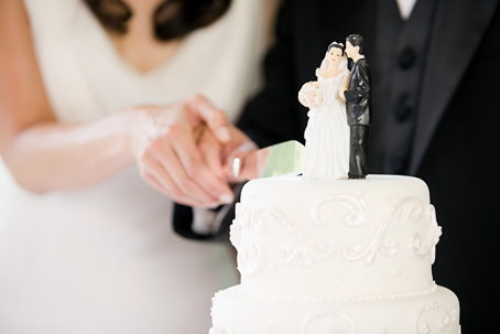 bride and groom cutting wedding cake